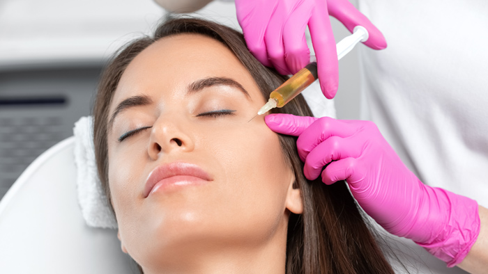Cosmetologist does revs pro 32 therapy on the face of a beautiful woman in a beauty salon. Women's cosmetology in the beauty salon.